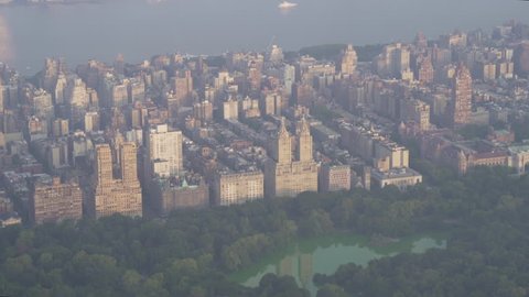 New York City Circa-2015, telephoto aerial view flying over Central Park in the morning, featuring buildings on Central Park West in the Upper West Side