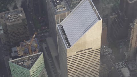New York City Circa-2015, daytime aerial view flying over Midtown Manhattan skyscrapers, crossing streets and avenues