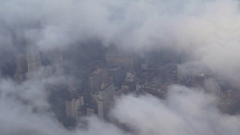 New York City Circa-2015, aerial view flying through fog and low level clouds, featuring office buildings in Lower Manhattan's Financial District