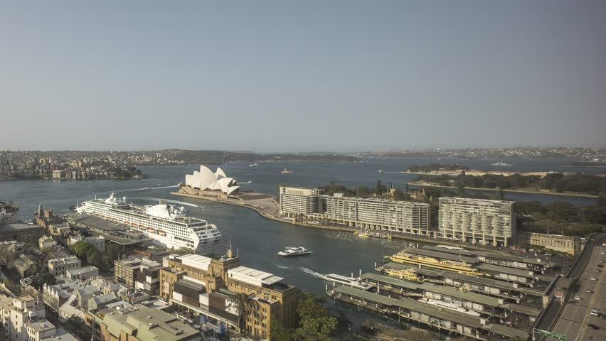 4k UHD time lapse of day to night to day, from sunset to sunrise at Sydney city skyline, aerial view. Pan right