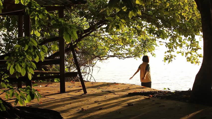 Lady exercising her arm on the vacation in the park