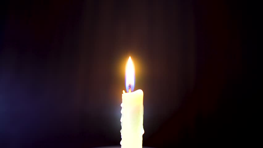  Candle isolated in a dark room illuminated slightly with a cool bluish light and being blown out watching the smoke dance rise and climb Royalty-Free Stock Footage #1017529390