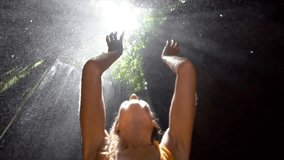 Young woman in tropical rainforest looking up at beautiful light and touching the rain drops with hands. People travel enjoying nature and life concept. Slow motion video - Powered by Shutterstock - Get 15% off with code: PIKWIZARD15