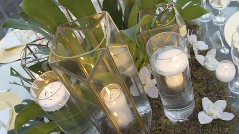 Table decoration of a candel inside a glass of a wedding party.