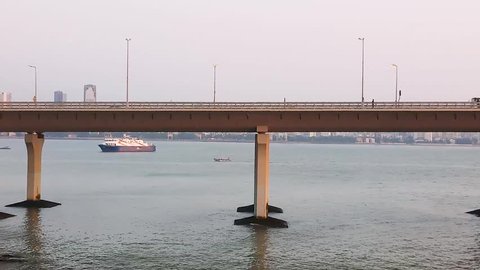 Mumbai, Maharashtra / India - 08 24 2018: Clip of a cruise ship and ferry from the shore