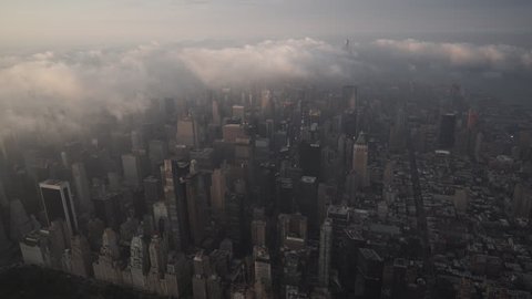 New York City Circa-2015, aerial view of Midtown Manhattan skyscrapers from Central Park, at sunrise, under fog and low level clouds