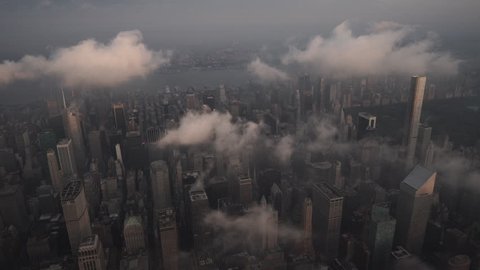 New York City Circa-2015, aerial view flying over Midtown Manhattan skyscrapers and the Upper East Side under low level clouds at sunrise