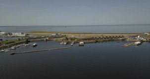 4K aerial sunny day video of circular highway around Saint Petersburg at Fort Konstantin harbour, dam gate, yacht club, Finnish Bay panorama, boats moored at Baltic Sea, near Russia's northern capital