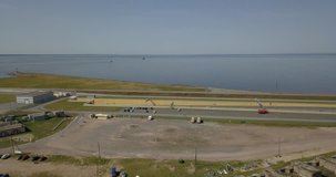 4K aerial sunny day video of circular highway around Saint Petersburg at Fort Konstantin harbour, dam gate, yacht club, Finnish Bay panorama, boats moored at Baltic Sea, near Russia's northern capital