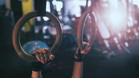 Girl working out with gymnastic rings at the crossfit gym - Powered by Shutterstock - Get 15% off with code: PIKWIZARD15