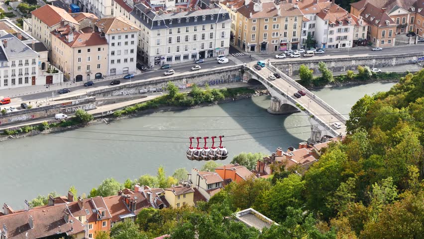 View of the Isère river in Grenoble, a town in the south-east of France, in the Alps. There is the cable car, with the cabins that go down to the station.