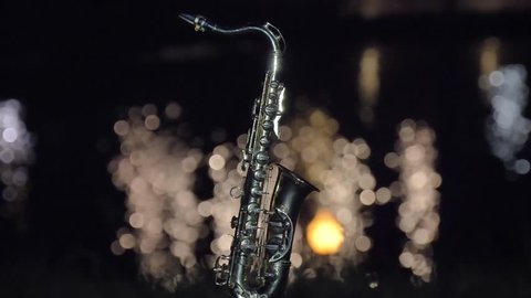 Night Saxophone near river and building 