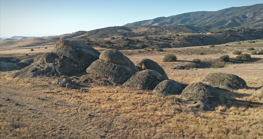 Aerial over the rolling hills and ancient rock formations of Carrizo Plain Monument. The San Andreas fault runs through the park.
