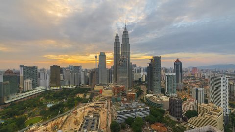 KUALA LUMPAR - CIRCA FEBRUARY 2016: View of KLCC Park and Petronas Twin Towers, Kuala Lumpur City Centre KLCC with busy construction area. Tilt down motion timelapse. Prores 4K.
