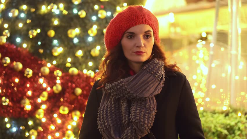 Beautiful woman in the street waiting for someone at Christmas time