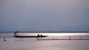 a boat man sails with passenger by old boat ferry in the lake on sunset - Powered by Shutterstock - Get 15% off with code: PIKWIZARD15