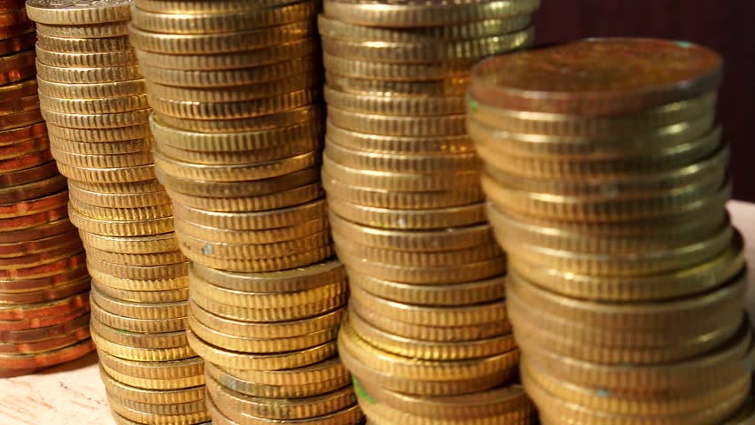 Stacks of Gold Coins isolated indoors on wooden table Royalty-Free Stock Footage #1017597730