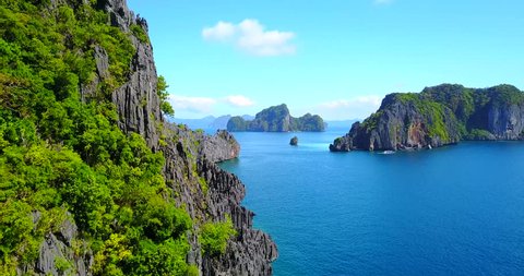 Dramatic Fly-By Of Rocky Ocean Cliffs - El Nido, Palawan, Philippines - Aerial View