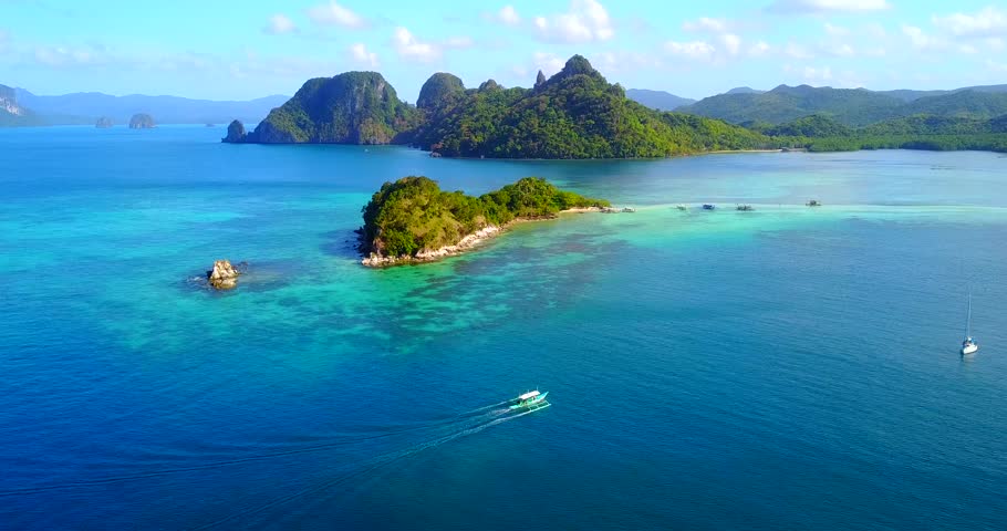Dramatic Aerial View Of El Nido Islands With Catamaran-Style Boat Traversing In Foreground - Palawan, Philippines Royalty-Free Stock Footage #1017609733