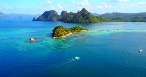 Dramatic Aerial View Of El Nido Islands With Catamaran-Style Boat Traversing In Foreground - Palawan, Philippines
