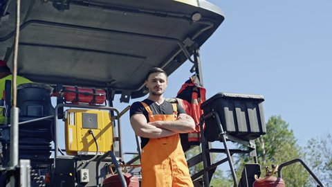 Workman standing in front of heavy duty machinery