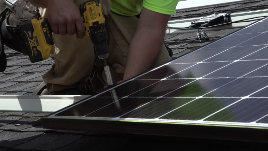Installation of residential rooftop solar panels | Shutterstock HD Video #1017616372