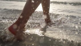 Girl feet and legs walking on water waves Slim female legs move on seafront Splash of water Holiday on beach in slow motion Perfect woman legs joyfully running on seashore Enjoy summer vacation - Powered by Shutterstock - Get 15% off with code: PIKWIZARD15