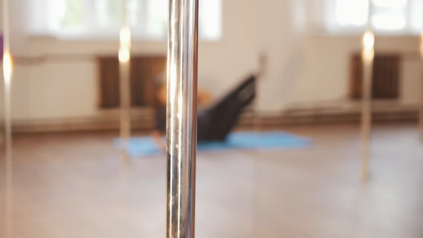 Girl warms up before training in a studio.