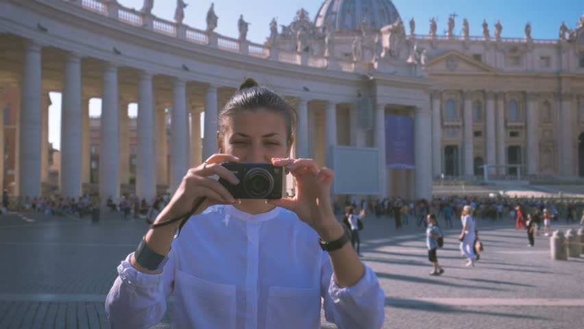girl does a photo on the central square of the Vatican Piazza San Pietro