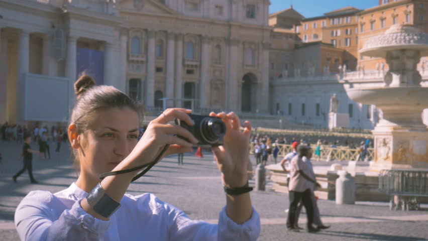 girl does a photo on the central square of the Vatican Piazza San Pietro