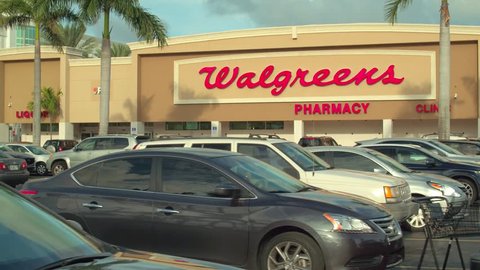 MIAMI, FL, USA - OCTOBER 8, 2018: Motion ground footage Walgreens pharmacy in shopping plaza
