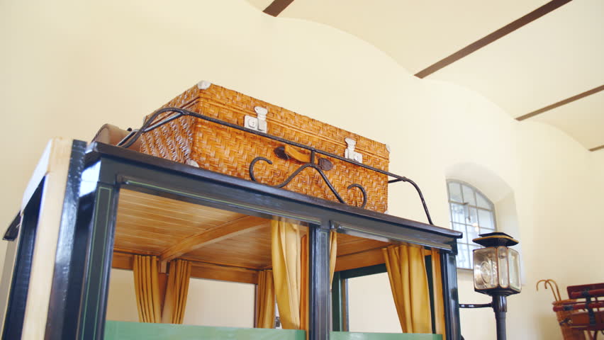 Passenger travel suitcase on retro horse carriage roof 4K. Long shot dolly slide of travel bags in focus. Vintage style carriage for travelers.