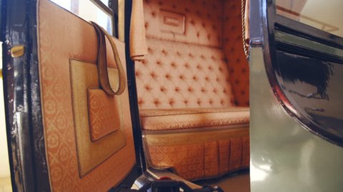 Dolly slide zoom-in to a vintage carriage inside 4K. Camera slide towards the inside the vintage carriage in focus with a stylish seat.