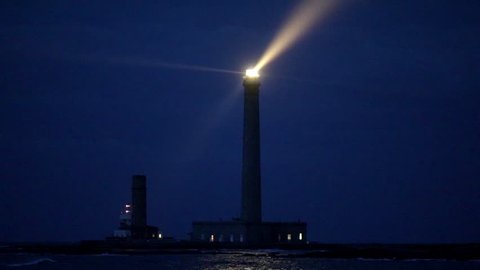 The powerful Gatteville lighthouse illuminated at dusk in Normandy, France, this is the second tallest stone lighthouse in Europe, 75m high.