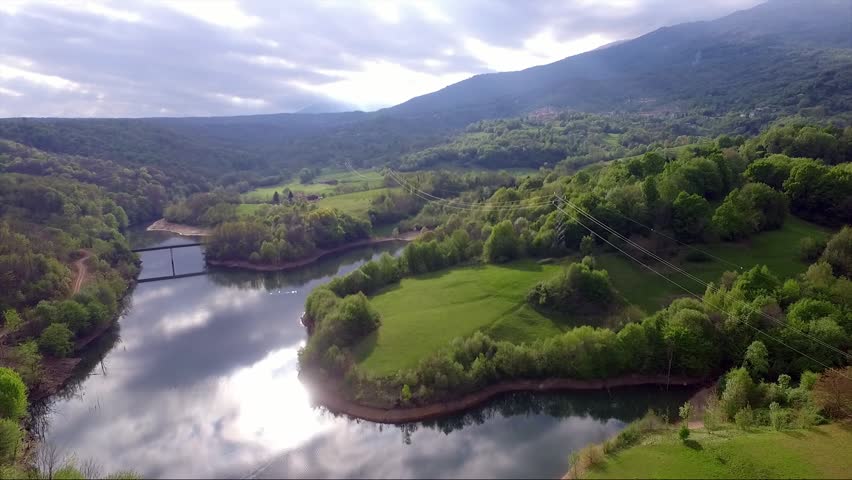 in flight on a dike in Italy in the sunset towards the green hills