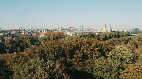 Reveal aerial footag from Munich with the River Isar - Drone Footage in a Park with Munich, Germany Skyline