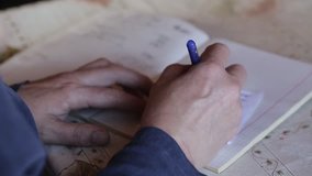 Video clip from the Siberian village. The farmer writes a check. Home Accounting.