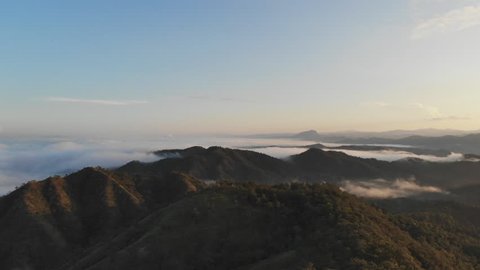 Landscape of Morning Mist with Mountain Layer at  north of Thailand. Aerial View. Flying over the high mountains in beautiful clouds . Aerial video shot.