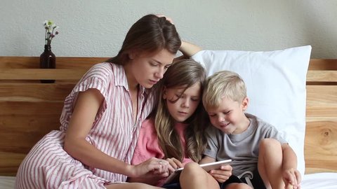 Mom and kids playing with tablet computer