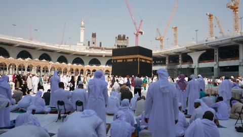 MECCA, SAUDI ARABIA-DECEMBER 2016 : Muslim pilgrims pray and circumambulate the Kaaba at Masjidil Haram in Makkah. Muslims all around the world face the Kaaba during prayer time.