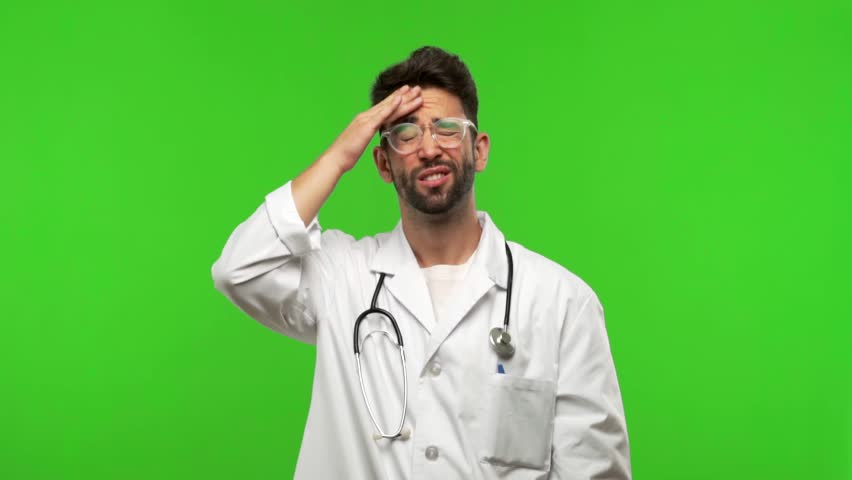 Young doctor man on green chroma worried and overwhelmed, forgetful, realize something, expression of shock at having made a mistake Royalty-Free Stock Footage #1017671953