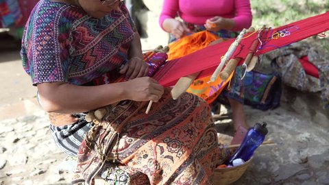 A woma in Guatemala making clothing by hand.