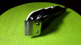Hair buzzer clippers isolated indoors on green table