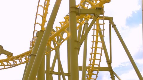 Close up of fast moving inverted roller coaster.