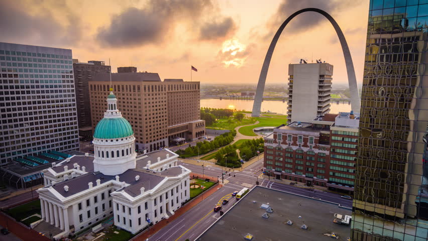 St. Louis, Missouri, USA downtown cityscape with the arch and courthouse at dusk.