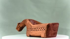 Wooden horse handmade of wood in the Russian force is spinning around its axis. Video 4k.