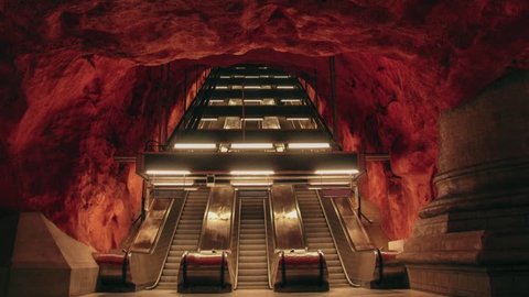 Stockholm city's beautiful metro station Radhuset. Fire style subway with dark atmosphere. Scandinavian place with escalator and empty place 