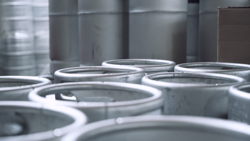Rack focus on beer containers at brewery