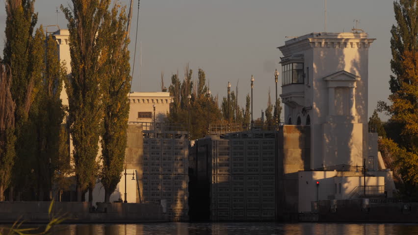 4K. The process of boat barges for the carriage of goods in the lock of the Volga-Don ship canal. Ships, water, yellow autumn leaves, beautiful reflection