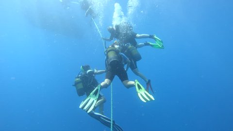 KAS, TURKEY - SEP 19: Group of scuba divers ascending on anchor line on September 19, 2018 in Kas, Turkey
